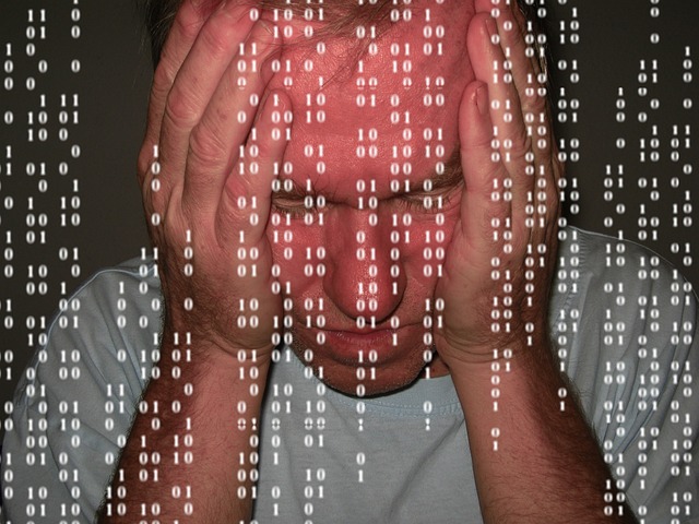 Man holding head over data
